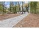 Long concrete driveway leading up to a charming home with a vibrant blue front door at 612 Saddlewood Dr, Lawrenceville, GA 30043