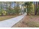 Long driveway leading to a charming house surrounded by mature trees at 612 Saddlewood Dr, Lawrenceville, GA 30043