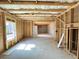 Unfinished basement with concrete floors, exposed wooden framing, and a door leading to another room at 66 Pine Creek Ct, Dallas, GA 30157