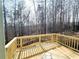 Unfinished wooden deck overlooking a wooded backyard at 66 Pine Creek Ct, Dallas, GA 30157