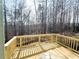 Unfinished wooden deck overlooking a wooded backyard at 66 Pine Creek Ct, Dallas, GA 30157