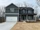 Charming two-story home with dark gray siding, white trim, a two-car garage, and a neatly maintained front yard at 66 Pine Creek Ct, Dallas, GA 30157