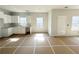 Bright, unfinished kitchen with white cabinets, gray countertops, and natural light at 66 Pine Creek Ct, Dallas, GA 30157