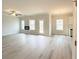 Spacious living room with an electric fireplace, rear deck access, and modern light gray flooring at 66 Pine Creek Ct, Dallas, GA 30157