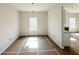 Bright, unfinished living room featuring clean white walls and abundant natural light, awaiting your personal touch at 66 Pine Creek Ct, Dallas, GA 30157