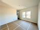 Bright, unfinished living room featuring clean white walls and abundant natural light, awaiting your personal touch at 66 Pine Creek Ct, Dallas, GA 30157