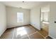 Bright, unfinished living room featuring clean white walls and abundant natural light, awaiting your personal touch at 66 Pine Creek Ct, Dallas, GA 30157