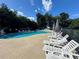 Resort-style pool with lounge chairs, shade umbrellas and lush landscaping at 66 Pine Creek Ct, Dallas, GA 30157