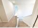 Staircase with carpet runner, white walls, and banister at 66 Pine Creek Ct, Dallas, GA 30157