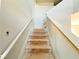 Unfinished wooden staircase leading upstairs with primed white walls and natural light at 66 Pine Creek Ct, Dallas, GA 30157