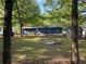 Spacious, green backyard featuring a fire pit and seating area for outdoor enjoyment at 1504 Sycamore Nw Dr, Kennesaw, GA 30152