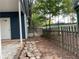 View of a backyard featuring a stone pathway, a mix of wooden and chainlink fences, and a garden at 1504 Sycamore Nw Dr, Kennesaw, GA 30152