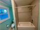 Tiled bathroom with tub/shower and window at 1504 Sycamore Nw Dr, Kennesaw, GA 30152