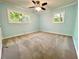 This is a bedroom with two windows and a ceiling fan at 1504 Sycamore Nw Dr, Kennesaw, GA 30152