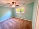 Bedroom with standard ceiling fan, carpeted floors, and natural light from the windows at 1504 Sycamore Nw Dr, Kennesaw, GA 30152