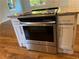 Kitchen island featuring stainless steel oven and cooktop with white cabinets and granite countertop at 1504 Sycamore Nw Dr, Kennesaw, GA 30152