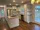 Modern kitchen with stainless steel appliances, granite countertops, and bright white cabinets at 1504 Sycamore Nw Dr, Kennesaw, GA 30152