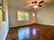 Well-lit living room featuring hardwood floors, a ceiling fan, and a door leading to the outside at 1504 Sycamore Nw Dr, Kennesaw, GA 30152