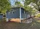 Side exterior view with stone retaining wall and utilities at 1504 Sycamore Nw Dr, Kennesaw, GA 30152