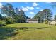 Expansive backyard featuring a lush lawn, mature trees, and plenty of space for outdoor activities at 28 Fawn Ct, Sharpsburg, GA 30277