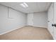 Neutral basement with carpet flooring, a drop ceiling, and a closet for storage at 28 Fawn Ct, Sharpsburg, GA 30277