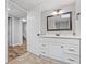 Bright bathroom featuring a white vanity with drawers and doors, a mirror, and adjacent doorways at 28 Fawn Ct, Sharpsburg, GA 30277