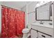 Cozy bathroom featuring holiday-themed shower curtain, classic vanity with framed mirror, and modern fixtures at 28 Fawn Ct, Sharpsburg, GA 30277