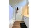 Bright bathroom with a white shower curtain, wooden floors, and white cabinets and walls at 28 Fawn Ct, Sharpsburg, GA 30277