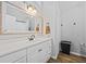 Bright bathroom featuring white cabinets, a large mirror, and modern fixtures at 28 Fawn Ct, Sharpsburg, GA 30277
