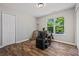 An empty bedroom with a modern desk and chair near the window with light shining in at 28 Fawn Ct, Sharpsburg, GA 30277