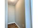 A narrow hallway features white trim, neutral paint, and wood-look floors with a visible electrical outlet at 28 Fawn Ct, Sharpsburg, GA 30277