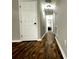 Hallway showcasing stylish flooring, neutral wall paint, and leading to other rooms with smooth transitions at 28 Fawn Ct, Sharpsburg, GA 30277