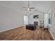 Cozy living room with a fireplace, wood-look flooring, and vaulted ceilings at 28 Fawn Ct, Sharpsburg, GA 30277