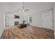 Bright living room featuring a fireplace, vaulted ceiling, and wood-look flooring at 28 Fawn Ct, Sharpsburg, GA 30277