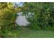 A shed is hidden amidst the lush greenery in the backyard of the home at 28 Fawn Ct, Sharpsburg, GA 30277