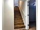 View of a wooden staircase with white railings and a light fixture at the top at 28 Fawn Ct, Sharpsburg, GA 30277