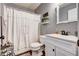 Bathroom features a white vanity and rustic décor, shower with curtain, and tile floors at 764 Whitby Dr, Douglasville, GA 30134
