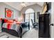 Bedroom featuring a bold red jersey art piece, black furniture, and chair by an arched window at 764 Whitby Dr, Douglasville, GA 30134