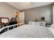 Neutral bedroom featuring light carpet, grey walls, vintage white dresser, and work desk at 764 Whitby Dr, Douglasville, GA 30134