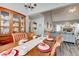 Formal dining room with hardwood table, decorative hutch, and view into adjacent living spaces at 764 Whitby Dr, Douglasville, GA 30134