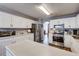 Bright kitchen featuring white cabinets, stainless steel appliances, and ample counter space at 764 Whitby Dr, Douglasville, GA 30134