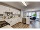 Spacious kitchen featuring white cabinets, stainless steel appliances, and a breakfast nook at 764 Whitby Dr, Douglasville, GA 30134