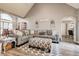 Comfortable living room featuring a gray sofa, patterned ottoman, and vaulted ceiling at 764 Whitby Dr, Douglasville, GA 30134