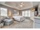Spacious main bedroom featuring neutral walls, carpet, vaulted ceiling, and sitting area by windows at 764 Whitby Dr, Douglasville, GA 30134