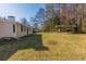 Expansive backyard featuring a large grassy area, mature trees, and a covered carport at 858 Commodore Nw Dr, Atlanta, GA 30318