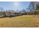 Large yard showcasing the home's exterior and the vast outdoor space, with established trees at 858 Commodore Nw Dr, Atlanta, GA 30318