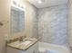 Bathroom vanity with a granite countertop and tiled shower with a tub at 858 Commodore Nw Dr, Atlanta, GA 30318