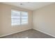 Clean bedroom featuring neutral tones and a bright window with blinds at 858 Commodore Nw Dr, Atlanta, GA 30318