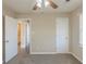Neutral bedroom showcasing access to the en suite bathroom, neutral carpet, and blinds at 858 Commodore Nw Dr, Atlanta, GA 30318