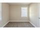 Neutral bedroom showing a bright window and the door to the closet at 858 Commodore Nw Dr, Atlanta, GA 30318